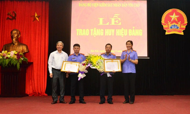 Phó Viện trưởng VKSNDTC Nguyễn Thị Thủy Khiêm và Trưởng Ban Tuyên giáo Đảng ủy Khối các cơ quan Trung ương Vũ Đức Nam trao Huy hiệu 30 năm tuổi Đảng và tặng hoa chúc mừng các Đảng viên