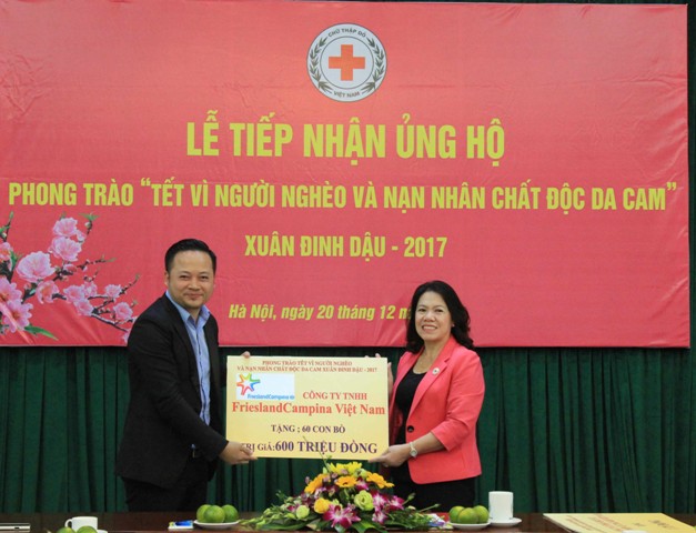 Đại diện FrieslandCampina Việt Nam (bên trái) trao bảng tượng trưng cho Chủ tịch Trung ương Hội Chữ thập đỏ Việt Nam